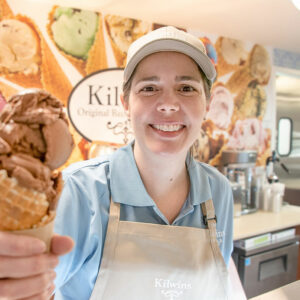 Kilwins employee holding ice cream cone